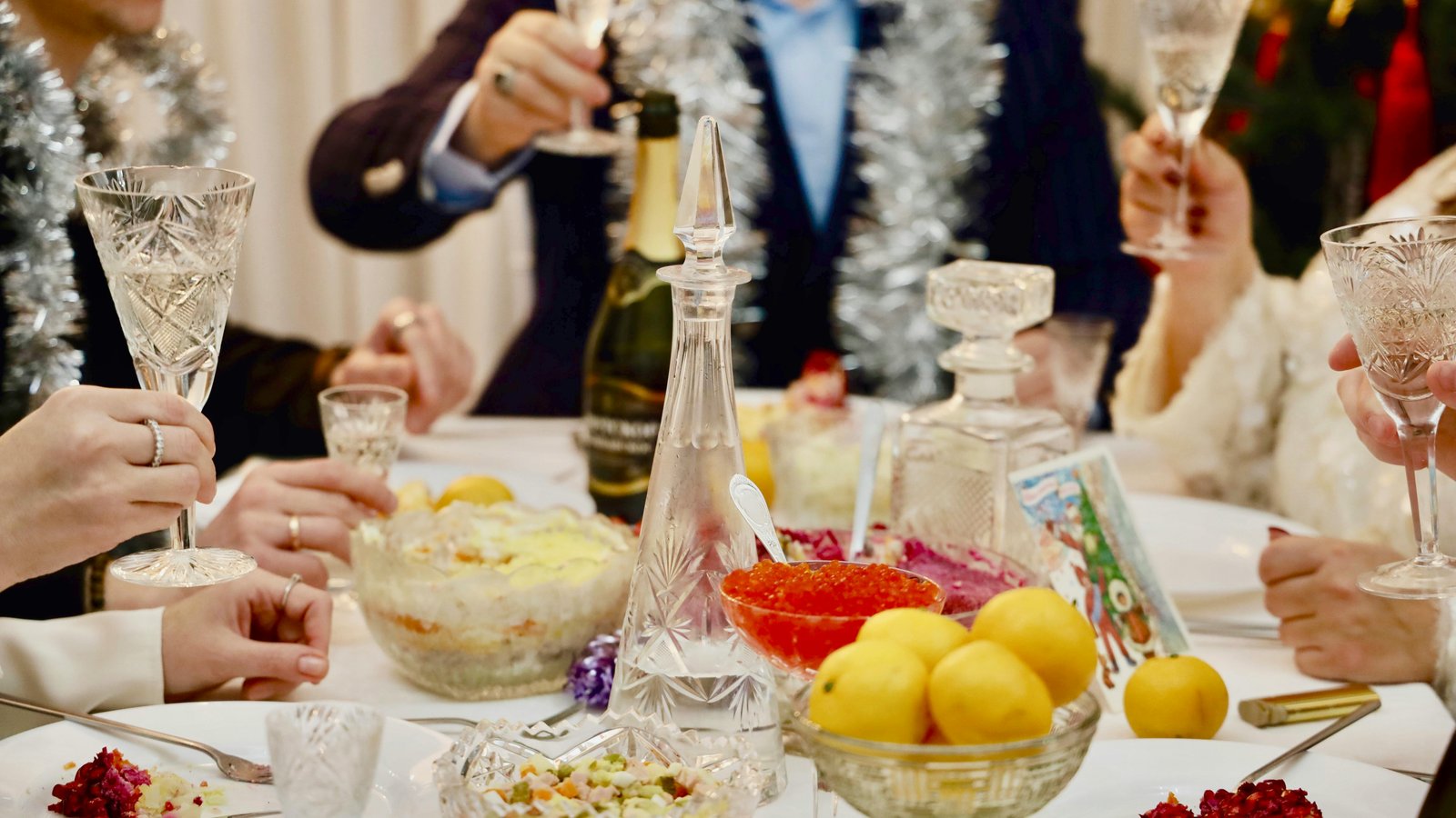 Elegant holiday table setting with plated appetizers and champagne glasses, ready for guests.