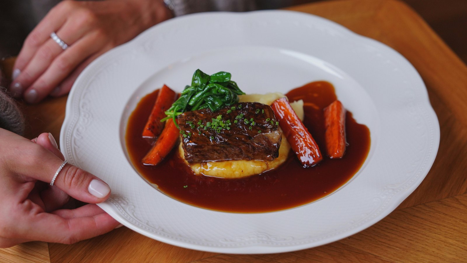 Chef Steve Ingber plating an elegant dinner course in a luxury mountain home kitchen.
