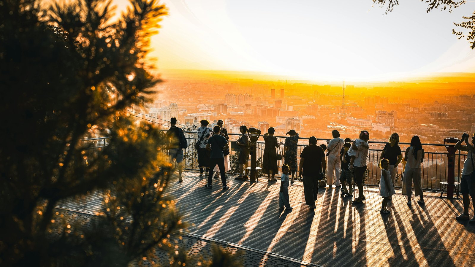 Elegant plated dinner overlooking Telluride mountains during golden hour with festival crowds below.
