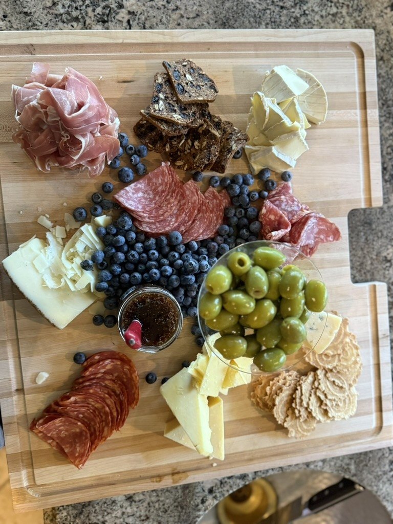 Charcuterie board with fruit and cheese