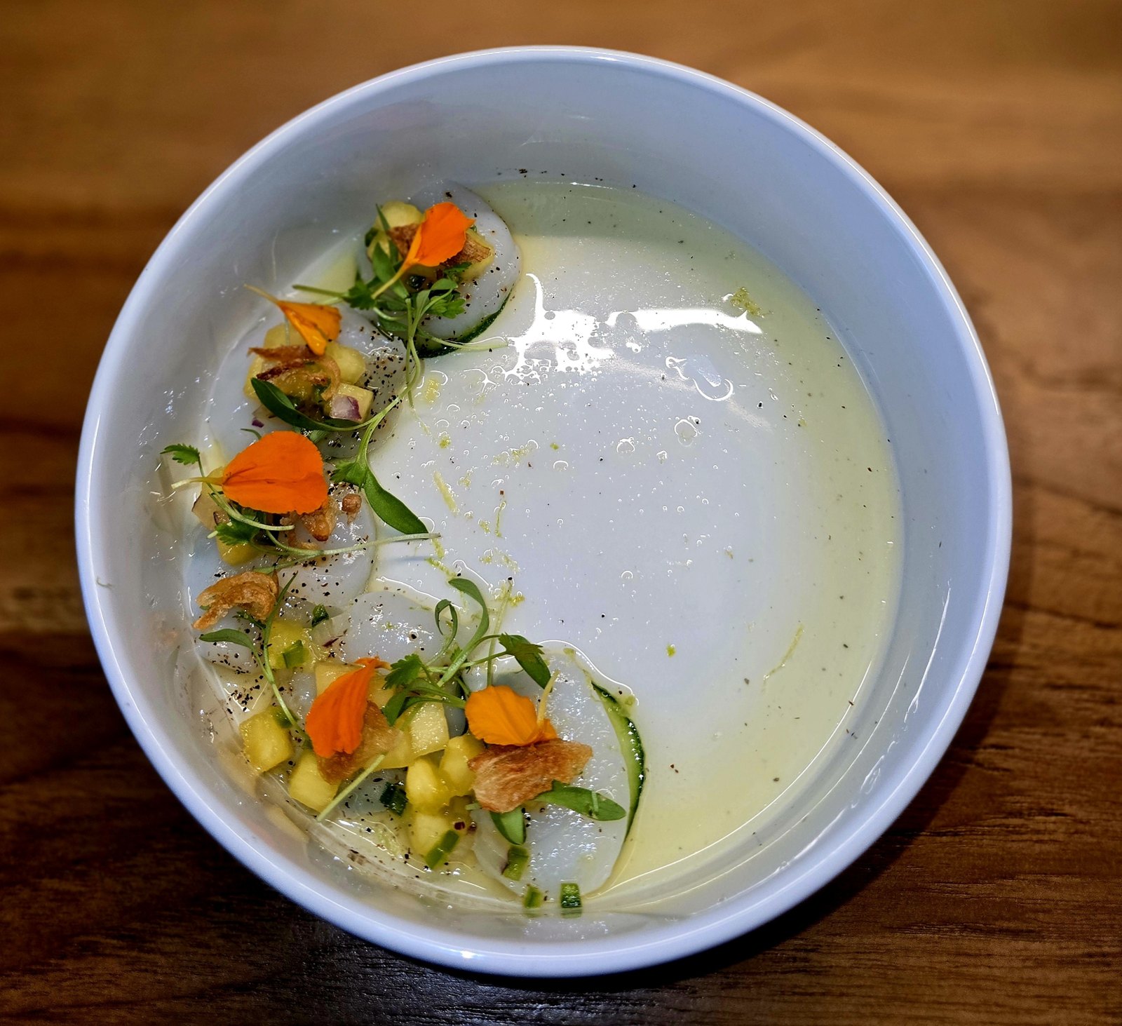 Fine-dining crudo in citrus broth
